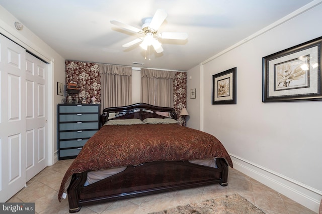 tiled bedroom featuring ceiling fan and a closet