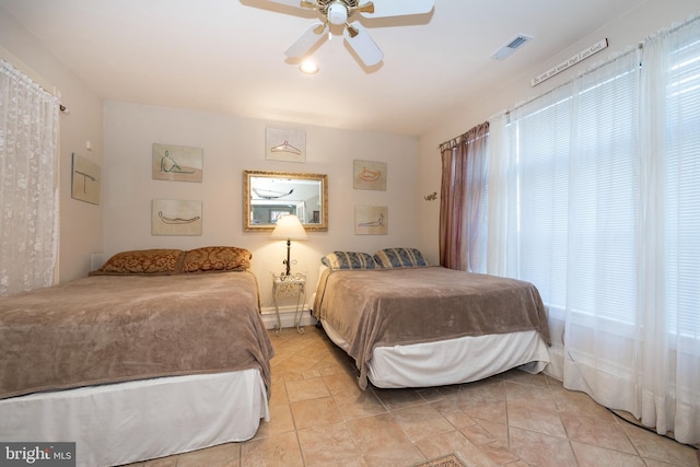 tiled bedroom with ceiling fan