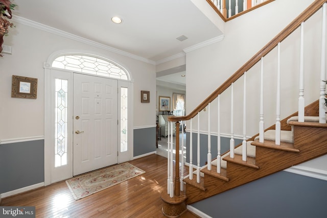 foyer with dark hardwood / wood-style floors and ornamental molding