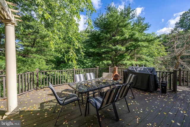 wooden terrace with a grill