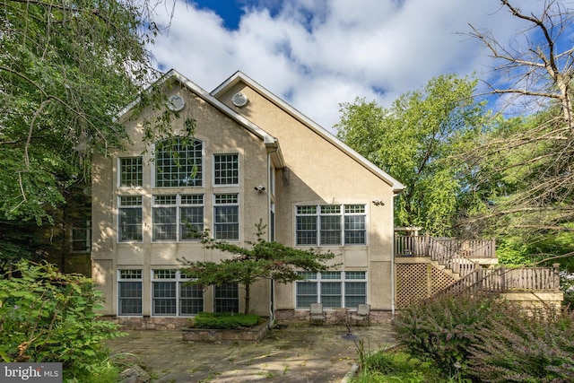 back of property featuring a patio