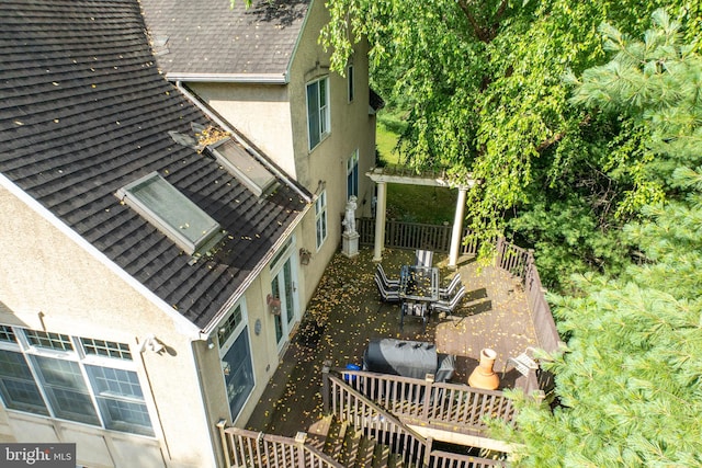 view of side of property with a patio and a wooden deck