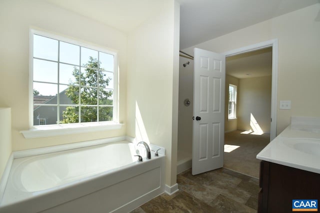 bathroom featuring vanity and a tub to relax in