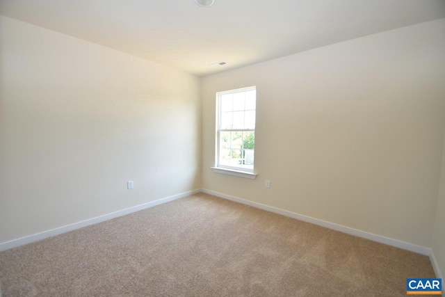 spare room with light carpet