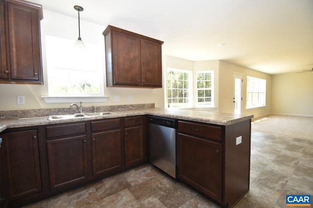 kitchen featuring kitchen peninsula, decorative light fixtures, stainless steel dishwasher, and a wealth of natural light