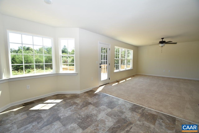 interior space with ceiling fan