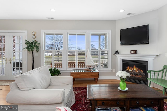 living room featuring french doors and hardwood / wood-style floors