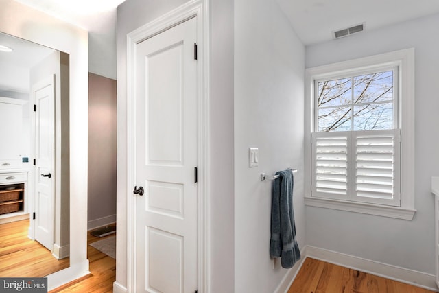 corridor with light hardwood / wood-style flooring