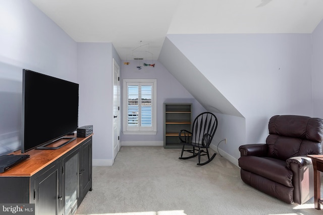 living area with light colored carpet and lofted ceiling