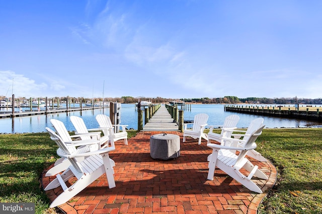 view of dock featuring a water view and a yard