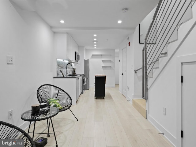 corridor with light hardwood / wood-style flooring