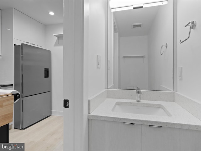 bathroom featuring hardwood / wood-style floors and vanity