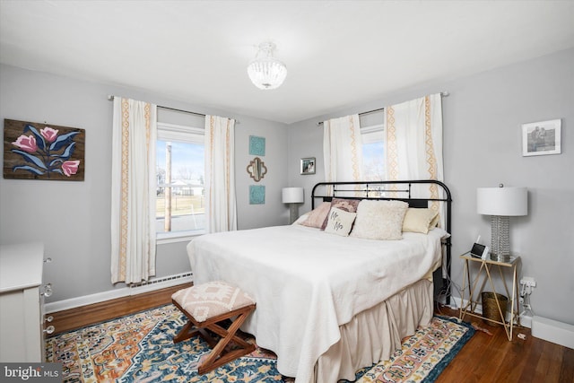 bedroom with dark hardwood / wood-style floors