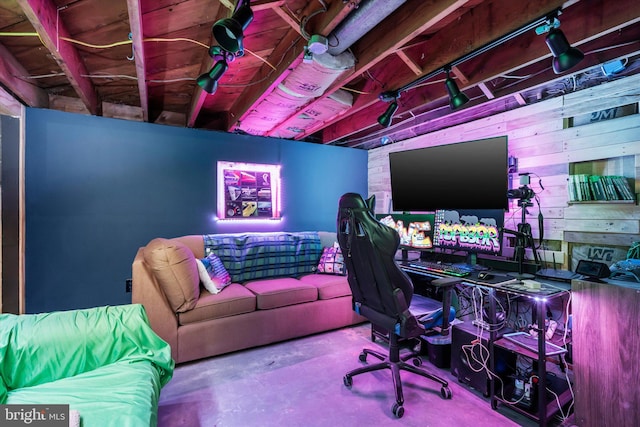 home office with wood walls and concrete flooring