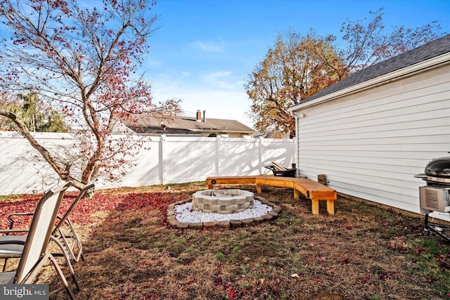 view of yard with a fire pit