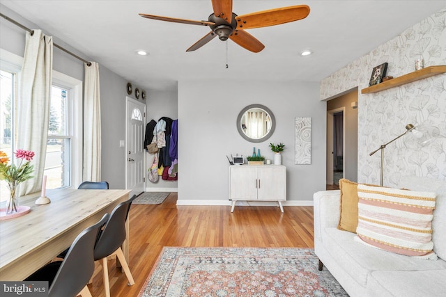 living room with ceiling fan and light hardwood / wood-style flooring