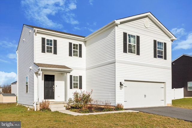 view of front property with a front yard and a garage