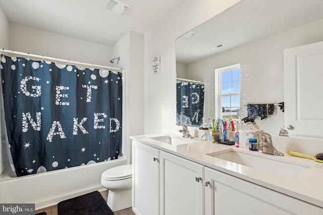 full bathroom featuring shower / bath combo with shower curtain, vanity, hardwood / wood-style floors, and toilet