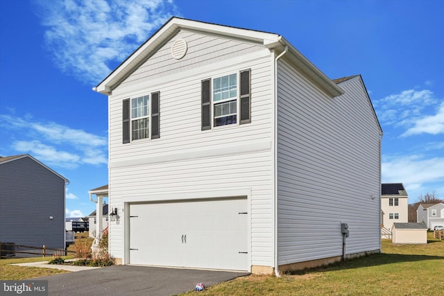 view of side of home with a yard and a garage