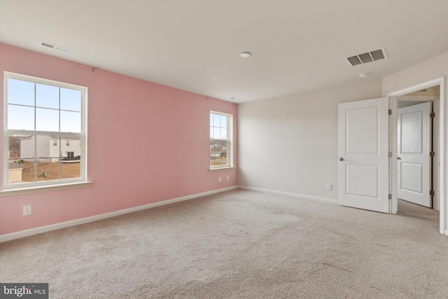 unfurnished room featuring light colored carpet