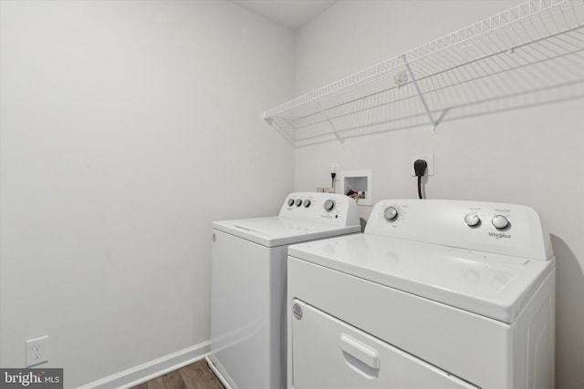 laundry area featuring dark hardwood / wood-style flooring and washer and dryer