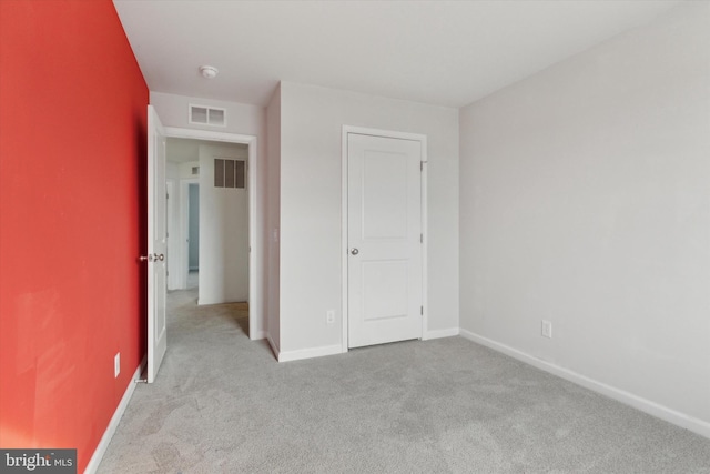 unfurnished bedroom with light colored carpet