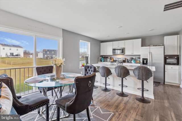 dining room featuring dark wood-type flooring and sink