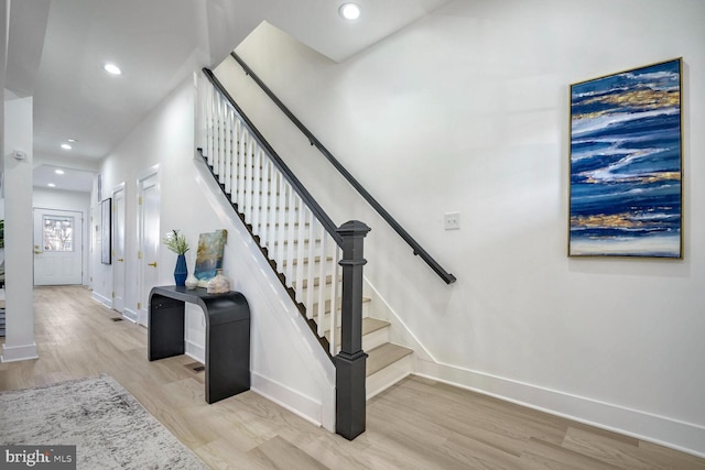 stairway with hardwood / wood-style floors