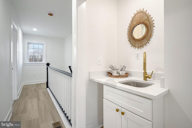 bar with sink and white cabinets