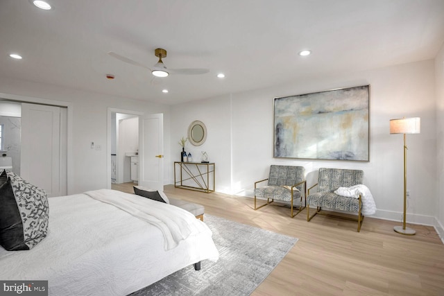 bedroom featuring ceiling fan, a closet, and light hardwood / wood-style flooring