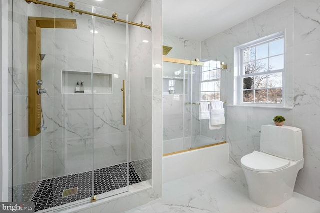 bathroom featuring combined bath / shower with glass door and toilet