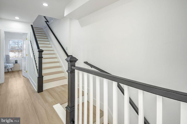 staircase featuring wood-type flooring