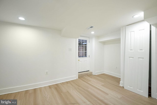 basement with light hardwood / wood-style floors