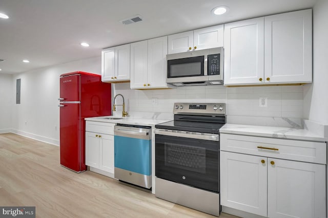 kitchen with white cabinets, stainless steel appliances, and sink