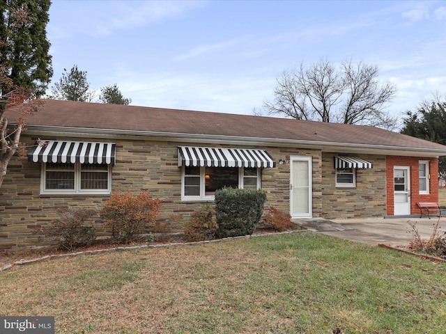 view of front facade with a patio and a front lawn