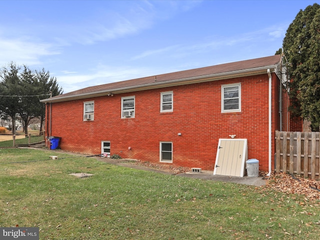 rear view of property featuring a lawn