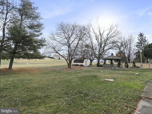 view of yard featuring a gazebo and a rural view