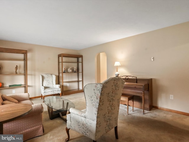 sitting room featuring light colored carpet