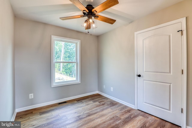 spare room with ceiling fan and light hardwood / wood-style flooring