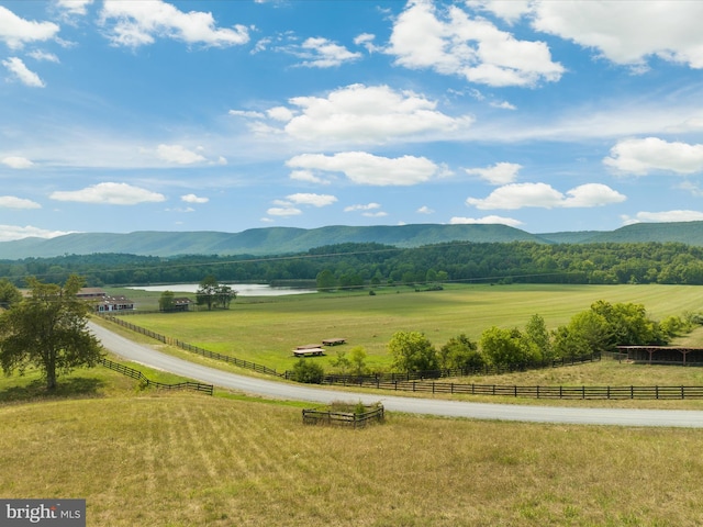 property view of mountains featuring a rural view and a water view