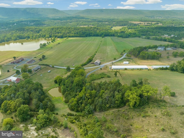 birds eye view of property featuring a water view and a rural view