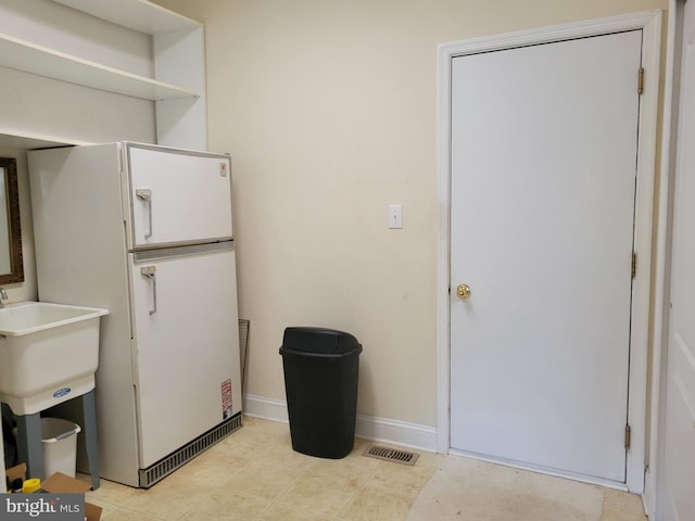 interior space featuring light tile patterned floors and sink