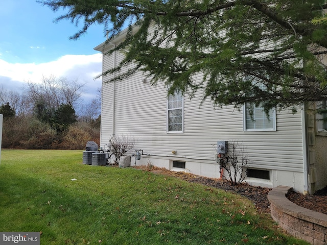 view of property exterior with a lawn