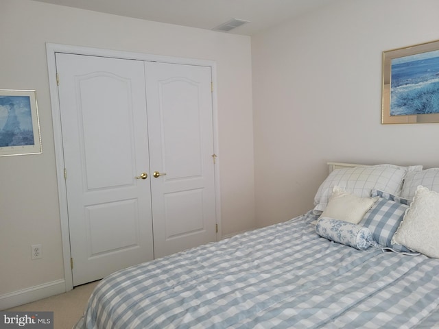 bedroom featuring a closet and light colored carpet