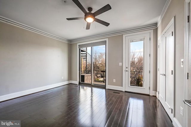 empty room featuring crown molding, ceiling fan, and dark hardwood / wood-style floors