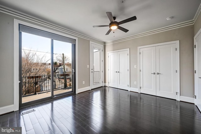 unfurnished bedroom featuring dark hardwood / wood-style flooring, access to outside, ceiling fan, and crown molding