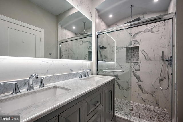 bathroom featuring vanity and a shower with shower door