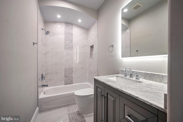 full bathroom featuring tiled shower / bath combo, toilet, and vanity