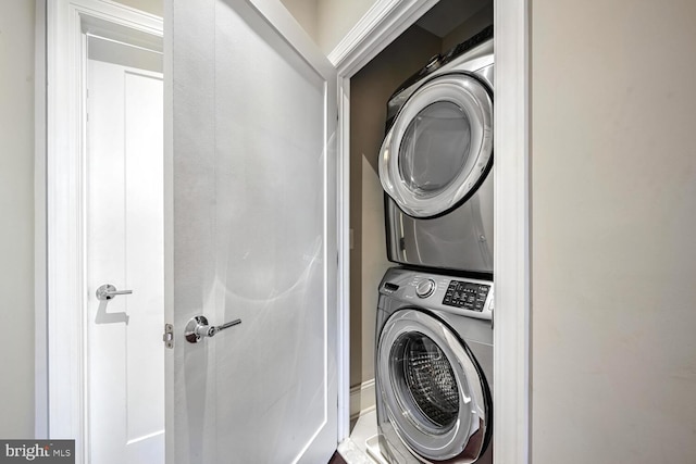 laundry area with stacked washing maching and dryer