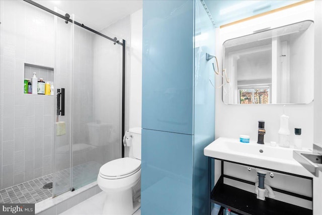 bathroom with tile patterned floors, a shower with door, and toilet